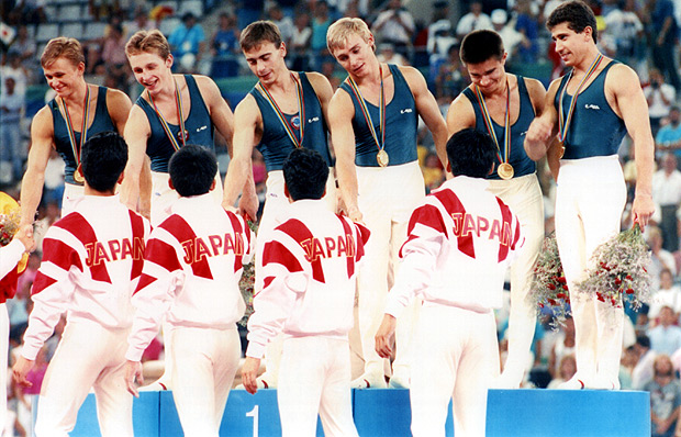 FILE - In this July 29, 1992, file photo, the Japan's bronze medalists in men's team gymnastics congratulate the gold medalists from the Unified Team during medal ceremonies at the Summer Olympics in Barcelona. The Unified Team consisted of 12 of the 15 former Soviet Union republics, Armenia, Azerbaijan, Belarus, Georgia, Kazakhstan, Kyrgyzstan, Moldova, Russia, Tajikistan, Turkmenistan, Ukraine, and Uzbekistan. The 475-member team earned a total of 112 medals, 45 of them that were gold. (Sven Creutzmann/IOPP via AP, Pool, File) ORG XMIT: NY160