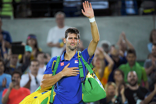 2016 Rio Olympics - Tennis - Preliminary - Men's Singles First Round - Olympic Tennis Centre - Rio de Janeiro, Brazil - 07/08/2016. Novak Djokovic (SRB) of Serbia reacts after losing his match against Juan Martin Del Potro (ARG) of Argentina. REUTERS/Toby Melville FOR EDITORIAL USE ONLY. NOT FOR SALE FOR MARKETING OR ADVERTISING CAMPAIGNS. ORG XMIT: OLYN834