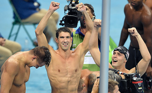 From left Nathan Adrian, Michael Phelps and Ryan Held from the United States, celebrate after winning the gold medal in the men's 4x100-meter freestyle final during the swimming competitions at the 2016 Summer Olympics, Sunday, Aug. 7, 2016, in Rio de Janeiro, Brazil. (AP Photo/Martin Meissner) ORG XMIT: OSWM557