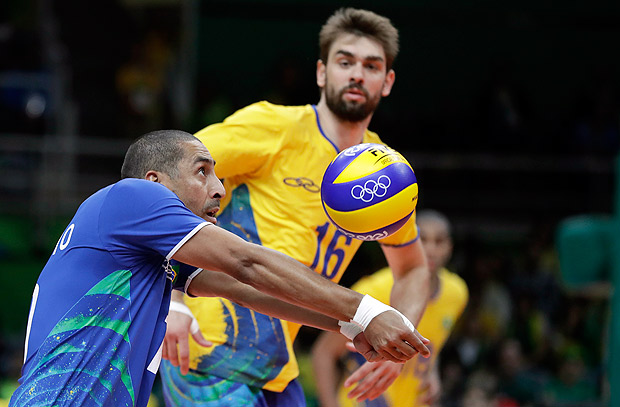 Sergio Dutra Santos, front, bumps as teammate Lucas Saatkamp watches during a men's preliminary volleyball match against the United States at the 2016 Summer Olympics in Rio de Janeiro, Brazil, Thursday, Aug. 11, 2016. (AP Photo/Jeff Roberson) ORG XMIT: OVOL162
