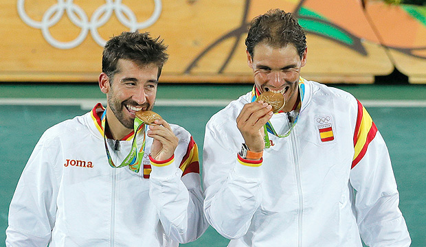 Spain Rafael Nadal, right, and Marc Lopez pose with the gold medals after defeating Romania's Horia Tecau and Florin Mergea in the men's doubles tennis competition at the 2016 Summer Olympics in Rio de Janeiro, Brazil, Friday, Aug. 12, 2016. (AP Photo/Vadim Ghirda) ORG XMIT: OVG145