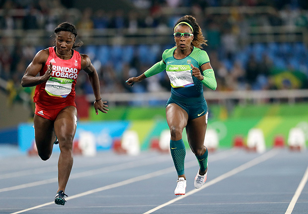 Brazil's Rosangela Santos, right, and Trinidad and Tobago's Semoy Hackett compete in a women's 100-meter heat during the athletics competitions of the 2016 Summer Olympics at the Olympic stadium in Rio de Janeiro, Brazil, Friday, Aug. 12, 2016. (AP Photo/David J. Phillip) ORG XMIT: OATH534