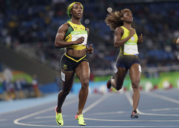 Jamaica's Shelly-Ann Fraser-Pryce, left, and Ecuador's Narcisa Landazuri compete in a women's 100-meter heat during the athletics competitions of the 2016 Summer Olympics at the Olympic stadium in Rio de Janeiro, Brazil, Friday, Aug. 12, 2016. (AP Photo/David J. Phillip) ORG XMIT: OATH574