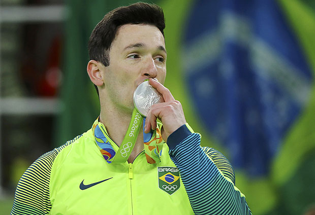 2016 Rio Olympics - Artistic Gymnastics - Victory Ceremony - Men's Floor Victory Ceremony - Rio Olympic Arena - Rio de Janeiro, Brazil - 14/08/2016. Diego Hypolito (BRA) of Brazil with his silver medal on the podium after the men's floor final. REUTERS/Mike Blake FOR EDITORIAL USE ONLY. NOT FOR SALE FOR MARKETING OR ADVERTISING CAMPAIGNS. ORG XMIT: OLYDN531