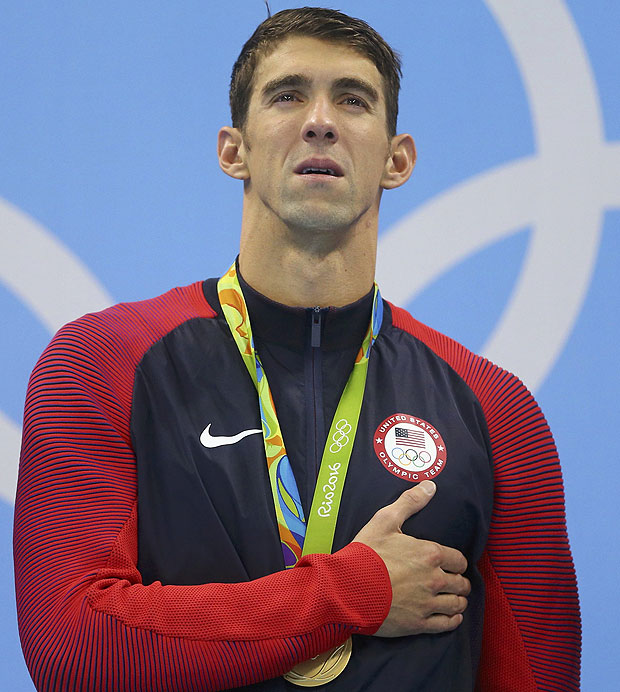 2016 Rio Olympics - Swimming - Victory Ceremony - Men's 4 x 100m Medley Relay Victory Ceremony - Olympic Aquatics Stadium - Rio de Janeiro, Brazil - 13/08/2016. Gold medallist Michael Phelps (USA) of USA stands to attention on the podium. REUTERS/Dominic Ebenbichler FOR EDITORIAL USE ONLY. NOT FOR SALE FOR MARKETING OR ADVERTISING CAMPAIGNS. ORG XMIT: OLYCN236