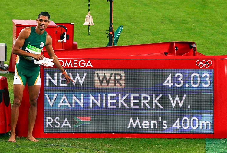 2016 Rio Olympics - Athletics - Final - Men's 400m Final - Olympic Stadium - Rio de Janeiro, Brazil - 14/08/2016. First placed Wayde van Niekerk (RSA) of South Africa poses next to information board. REUTERS/David Gray FOR EDITORIAL USE ONLY. NOT FOR SALE FOR MARKETING OR ADVERTISING CAMPAIGNS. ORG XMIT: CVI11200