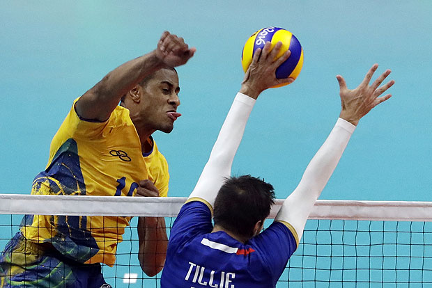Brazil's Mauricio Borges Almeida Silva, left, spikes the ball as France's Kevin Tillie blocks during a men's preliminary volleyball match at the 2016 Summer Olympics in Rio de Janeiro, Brazil, Monday, Aug. 15, 2016. (AP Photo/Matt Rourke) ORG XMIT: OVOL239