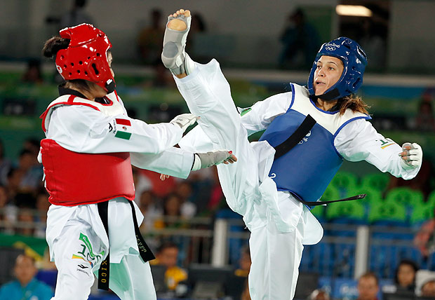 Adilene Manjarrez Bastidas from Mexico, left, and Iris Sing from Brazil compete in women's -49kg Taekwondo match at the 2016 Summer Olympics in Rio de Janeiro, Brazil, Wednesday, Aug. 17, 2016. (AP Photo/Vincent Thian) ORG XMIT: OTAE324