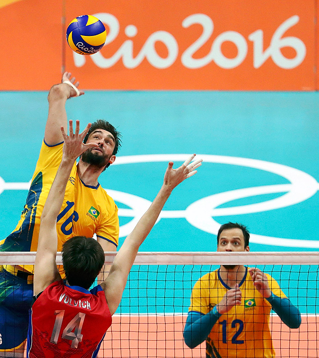 2016 Rio Olympics - Volleyball - Men's Semifinals Russia v Brazil - Maracanazinho - Rio de Janeiro, Brazil - 19/08/2016. Lucas (BRA) of Brazil spikes the ball as Artem Volvich (RUS) of Russia tries to block. REUTERS/Yves Herman FOR EDITORIAL USE ONLY. NOT FOR SALE FOR MARKETING OR ADVERTISING CAMPAIGNS. ORG XMIT: OLYSS774