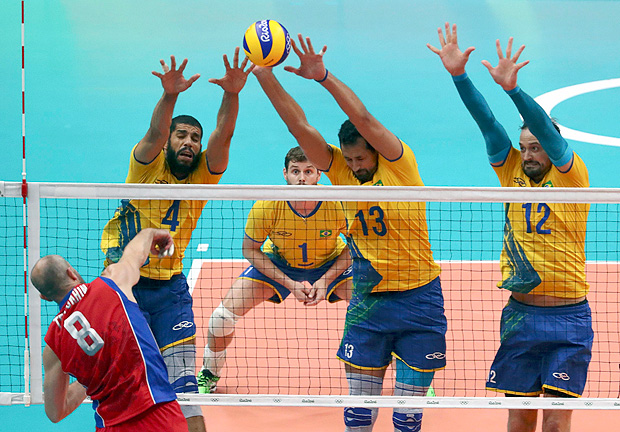 2016 Rio Olympics - Volleyball - Men's Semifinals Russia v Brazil - Maracanazinho - Rio de Janeiro, Brazil - 19/08/2016. Sergey Tetyukhin (RUS) of Russia spikes as Wallace Leandro De Souza (BRA) of Brazil, Mauricio De Souza (BRA) of Brazil and Lipe (BRA) of Brazil block. REUTERS/Yves Herman FOR EDITORIAL USE ONLY. NOT FOR SALE FOR MARKETING OR ADVERTISING CAMPAIGNS. ORG XMIT: OLYSS778