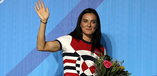 Yelena Isinbayeva, Russia's pole vault world record holder, waves as she leaves a news conference at the 2016 Summer Olympics in Rio de Janeiro, Brazil, Friday, Aug. 19, 2016. Isinbayeva announced her retirement from competition during the conference. (AP Photo/Gregory Bull) ORG XMIT: OBVL103