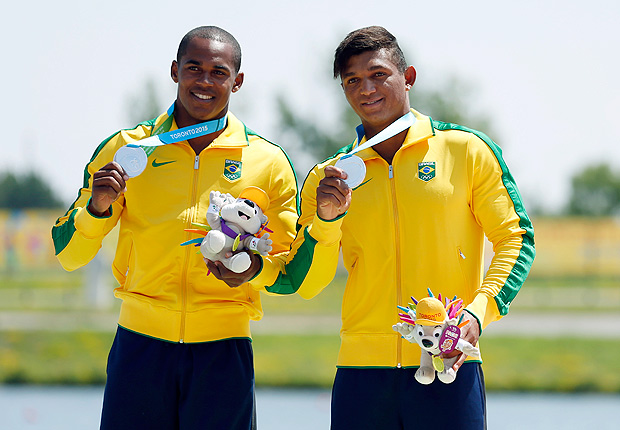 Jul 13, 2015; Welland, Ontario, CAN; Erlon De Souza Silva (left) and Isaquias Queiroz Dos Santos of Brazil (right) celebrate on the podium after placing second in the men's C2 canoeing 1000m final during the 2015 Pan Am Games at Welland Pan Am Flatwater Centre. Mandatory Credit: Jeff Swinger-USA TODAY Sports ORG XMIT: USATSI-230612