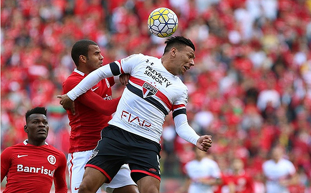 Chvez, do So paulo, disputa a bola com Ernando, do Inter, neste domingo (21)