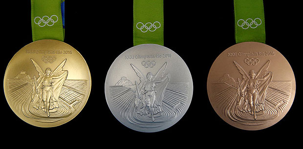Ask athletes what goes into Olympic gold medals, and they will likely say sweat and years of training. For Brazil's National Mint the answer is simpler: recycled silver. The 500-gram Olympic gold medals that athletes will be competing for in Rio de Janeiro are nearly 99 percent silver. They contain just 1.2 percent gold, mostly used as plating. The medals are the most sustainable in Olympic history. Much of the silver is recycled from old mirrors and X-ray plates. The gold is free of mercury, which is often used to separate gold from ore and can poison local ecosystems if not carefully disposed of. Nike, the winged goddess of victory in Ancient Greece, is minted on one side below the five Olympic rings, while the discipline for which the medal has been won is engraved along its edge. The other side bears the Rio 2016 logo. REUTERS/Sergio Moraes SEARCH "OLYMPIC MINT" FOR THIS STORY. SEARCH "THE WIDER IMAGE" FOR ALL STORIES TPX IMAGES OF THE DAY ORG XMIT: PXP00