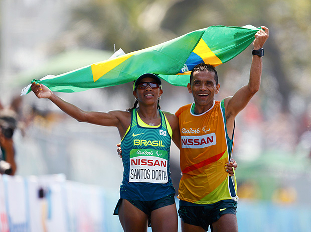 2016 Rio Paralympics - Athletics - Women's Marathon - T12 - Fort Copacabana, Rio de Janeiro, Brazil - 18/09/2016. Edneusa de Jesus Santos Dorta of Brazil celebrates with her guide after winning the bronze medal in the event. REUTERS/Jason Cairnduff FOR EDITORIAL USE ONLY. NOT FOR SALE FOR MARKETING OR ADVERTISING CAMPAIGNS. ORG XMIT: OLYHB54