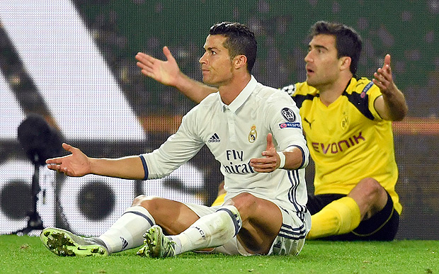 Real Madrid's Cristiano Ronaldo, left, and Dortmund's Sokratis Papastathopoulos raise their hands after making contact during the Champions League group F soccer match between Borussia Dortmund and Real Madrid in Dortmund, Germany, Tuesday, Sept. 27, 2016. (AP Photo/Martin Meissner) ORG XMIT: FOS246