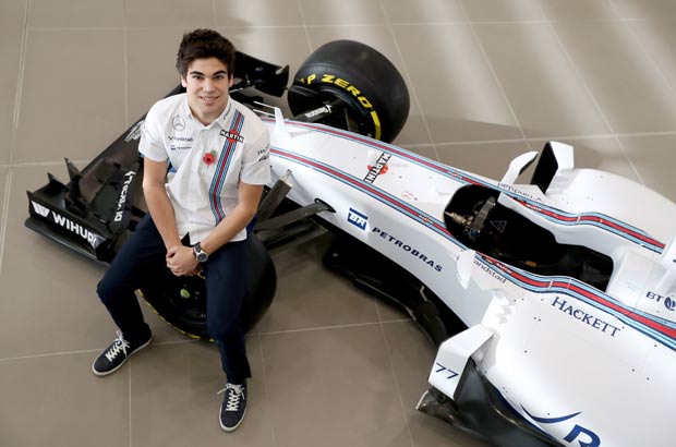 Williams driver for 2017 Lance Stroll sits on a car during the 2017 Formula One driver line-up at Williams headquarters in Grove, southern England, Thursday, Nov. 3, 2016. Canadian teenager Lance Stroll is set to be the youngest driver in Formula One next season after being confirmed in the Williams lineup. (David Davies/PA via AP) ORG XMIT: LON809