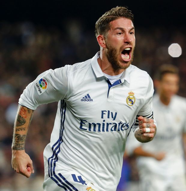 Real Madrid's defender Sergio Ramos celebrates after scoring the equalizer during the Spanish league football match FC Barcelona vs Real Madrid CF at the Camp Nou stadium in Barcelona on December 3, 2016. / AFP PHOTO / PAU BARRENA