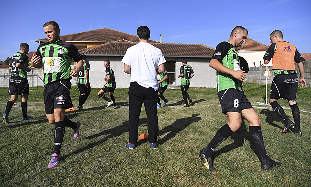  Players with FK Trepca, a team from Mitrovica, Kosovo, warm up before a soccer match in Mrcajevci, Serbia, Oct. 2, 2016. The team sang old Yugoslav songs on the bus ride across the border to compete in the Serbian fourth-tier soccer league; both FK Trepca and KF Trepca, a Kosovar Albanian team, claim the decades of history that came before war tore apart the region. (James Hill/The New York Times)  NO SALES  - XNYT47 