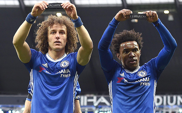 Chelsea's Brazilian midfielder Willian (R) and Chelsea's Brazilian defender David Luiz hold up their black armbands as they celebrate Willian scoring his team's second goal during the English Premier League football match between Manchester City and Chelsea at the Etihad Stadium in Manchester, north west England, on December 3, 2016. / AFP PHOTO / Paul ELLIS / RESTRICTED TO EDITORIAL USE. No use with unauthorized audio, video, data, fixture lists, club/league logos or 'live' services. Online in-match use limited to 75 images, no video emulation. No use in betting, games or single club/league/player publications. /