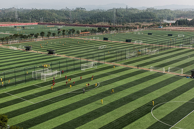 Some of the 48 fields at the Evergrande Football School, the worldÕs biggest soccer boarding academy, in Qingyuan, China, Dec. 6, 2016. While China has excelled at individual sports that demand intense discipline from an early age, the country has not done as well at fostering group sports, where skills like teamwork and improvisation count as much as personal virtuosity. (Gilles Sabrie/The New York Times)