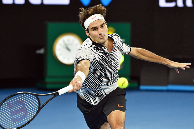 Switzerland's Roger Federer hits a return against Switzerland's Stanislas Wawrinka during their men's singles semi-final match on day 11 of the Australian Open tennis tournament in Melbourne on January 26, 2017. / AFP PHOTO / PETER PARKS / IMAGE RESTRICTED TO EDITORIAL USE - STRICTLY NO COMMERCIAL USE