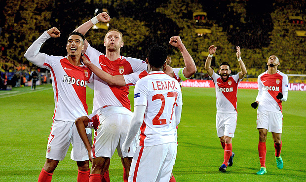 Monaco's players celebrate scoring during the UEFA Champions League 1st leg quarter-final football match BVB Borussia Dortmund v Monaco in Dortmund, western Germany on April 12, 2017. The match had been postponed after three explosions hit German football team Borussia Dortmund's bus late on April 11, 2017 ahead of a Champions League home game. / AFP PHOTO / Sascha Schuermann