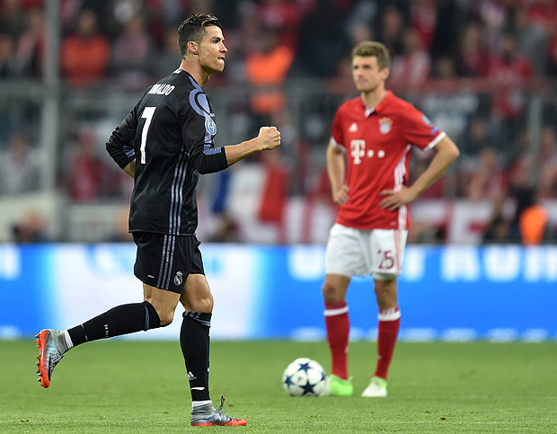 Real Madrid's Portuguese striker Cristiano Ronaldo reacts after his first goal during the UEFA Champions League 1st leg quarter-final football match FC Bayern Munich v Real Madrid in Munich, southen Germany on April 12, 2017. Security was ratcheted up in Munich, one day after three explosions rocked the team bus of German football club Borussia Dortmund minutes after the bus set off to a planned Champions League game against Monaco on Tuesday night (April 11, 2017). / AFP PHOTO / Christof STACHE ORG XMIT: CST036
