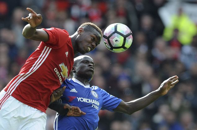 Manchester United's Paul Pogba and Chelsea's N'Golo Kante, rear, challenge for the ball during the English Premier League soccer match between Manchester United and Chelsea at Old Trafford stadium in Manchester, Sunday, April 16, 2017.(AP Photo/ Rui Vieira) ORG XMIT: FAS126