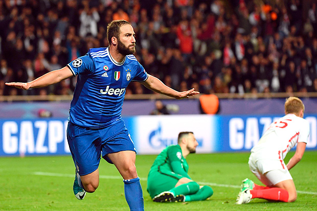 Juventus' forward from Argentina Gonzalo Higuain reacts after scoring a second goal during the UEFA Champions League semi-final first leg football match Monaco vs Juventus at the Stade Louis II stadium in Monaco on May 3, 2017. / AFP PHOTO / Anne-Christine POUJOULAT