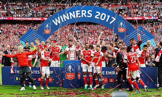 Britain Soccer Football - Arsenal v Chelsea - FA Cup Final - Wembley Stadium - 27/5/17 Arsenal celebrate with the trophy after winning the FA Cup finalReuters / Darren Staples EDITORIAL USE ONLY. No use with unauthorized audio, video, data, fixture lists, club/league logos or "live" services. Online in-match use limited to 45 images, no video emulation. No use in betting, games or single club/league/player publications. Please contact your account representative for further details. ORG XMIT: AI