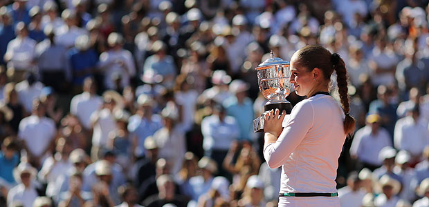Latvia's Jelena Ostapenko holds the cup after defeating Romania's Simona Halep in their final match of the French Open tennis tournament at the Roland Garros stadium, Saturday, June 10, 2017 in Paris. Ostapenko won 4-6, 6-4, 6-3. (AP Photo/David Vincent) ORG XMIT: ROG226