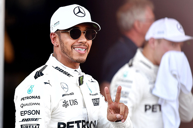 Pole position winner Mercedes' British driver Lewis Hamilton celebrates after the qualifying session for the Formula One Azerbaijan Grand Prix at the Baku City Circuit in Baku on June 24, 2017. / AFP PHOTO / ANDREJ ISAKOVIC