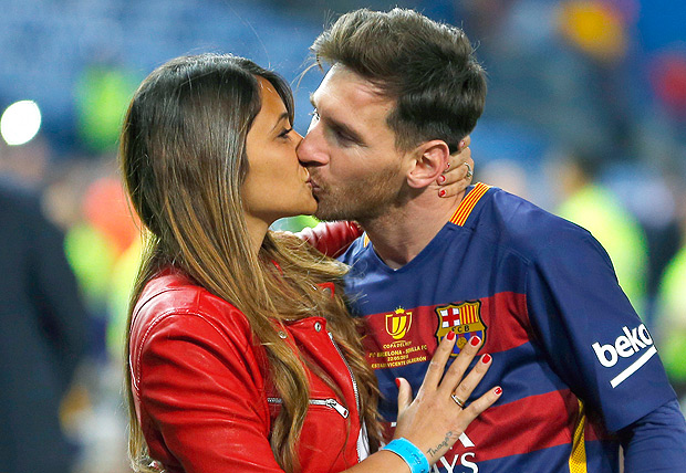 FILE - This is a Sunday, May 22, 2016 file photo of Barcelona's Lionel Messi, kisses his girlfriend Antonella Roccuzzo as they celebrate after winning the final of the Copa del Rey soccer match between FC Barcelona and Sevilla FC at the Vicente Calderon stadium in Madrid. Messi who will be the center of the attentions on Friday June 30, 2017 in his hometown of Rosario, Argentina,where he will be marrying 29-year-old Antonella Roccuzzo, his childhood friend and mother of his two children. (AP Photo/Francisco Seco/ File) ORG XMIT: LON125