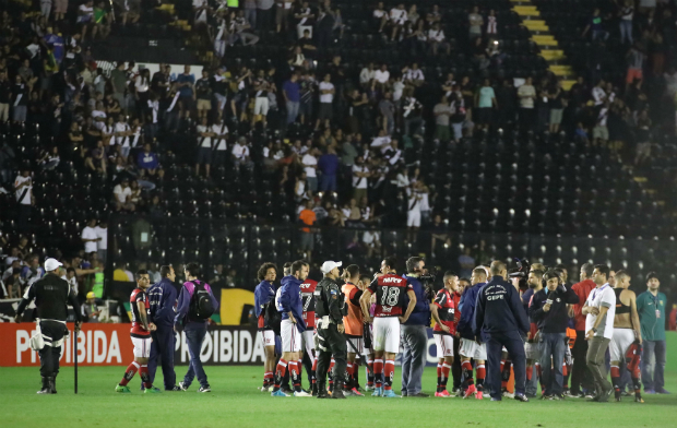 Jogadores do Flamengo aguardam no gramado aps vascanos tentarem invadir o campo