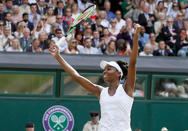 Venus Williams of the United States celebrates after beating Britain's Johanna Konta in their Women's Singles semifinal match on day nine at the Wimbledon Tennis Championships in London Thursday, July 13, 2017. (AP Photo/Kirsty Wigglesworth) ORG XMIT: WIM219