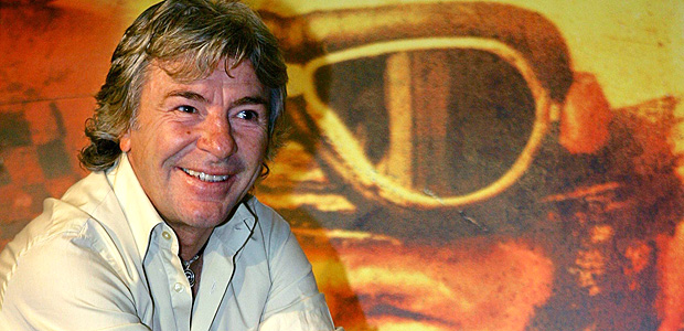 ORG XMIT: 004901_0.tif Spain's motorcycling legend Angel Nieto poses on an old motorcycle during a photocall in Madrid November 21, 2005. Nieto, thirteen time World Motorcycling champion, promoted a documentary about his life "Angel Nieto 12+1" which will open in Spain next November 25. REUTERS/Sergio Perez 