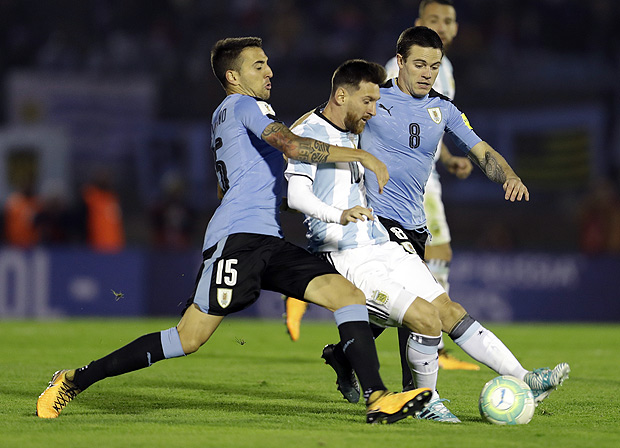 Argentina's Lionel Messi fights for the ball with Uruguay's Matias Vecino during a 2018 World Cup qualifying soccer match in Montevideo, Uruguay, Thursday, Aug. 31, 2017.(AP Photo/Natacha Pisarenko)