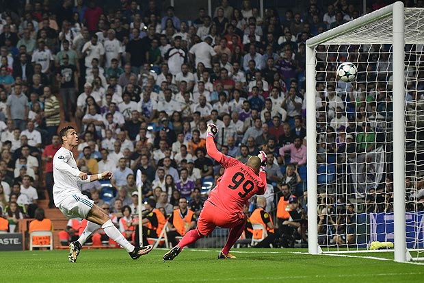 Real Madrid's forward from Portugal Cristiano Ronaldo (L) scores a goal to APOEL Nicosia's goalkeeper from the Netherlands Boy Waterman that will be cancelled by line referee during the UEFA Champions League football match Real Madrid CF vs APOEL FC at the Santiago Bernabeu stadium in Madrid on September 13, 2017. / AFP PHOTO / PIERRE-PHILIPPE MARCOU