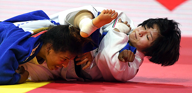 Japan's Tsukasa Yoshida (white) competes with Brazil's Rafaela Silva (blue) during their fight of the team category final at the World Judo Championships in Budapest on September 3, 2017. / AFP PHOTO / ATTILA KISBENEDEK
