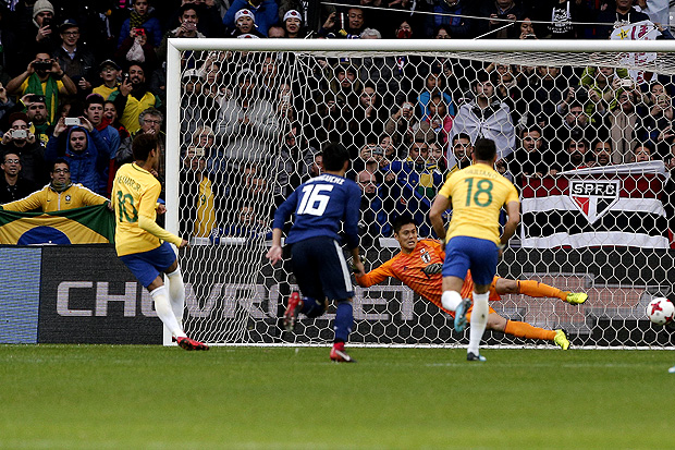 Brazil's Neymar, left, kicks a penalty shot to score his side opening goal during their international friendly soccer match Brazil against Japan at the Pierre Mauroy stadium in Lille, northern France, Friday, Nov. 10, 2017. (AP Photo/Michel Spingler) ORG XMIT: LIL104