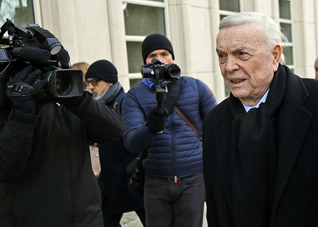 Jose Maria Marin, of Brazil, right, is followed by reporters as he arrives to federal court in the Brooklyn borough of New York, Wednesday, Dec. 13, 2017. Closing arguments are set to take place in the New York trial of three former South American soccer officials charged in the bribery scandal engulfing the sport's governing body. (AP Photo/Seth Wenig) ORG XMIT: NYSW104