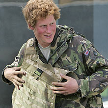 Britain's Prince Harry, seen shortly after his return from active duty in Afghanistan, removes his body armor as he leaves the Royal Air Force's Brize Norton air base in Oxfordshire, southern England, Saturday, March 1, 2008. Prince Harry returned to Britain on Saturday after his 10-week stint serving with the military in Afghanistan was cut short by media disclosure of his secret deployment. (AP Photo/Lefteris Pitarakis) 