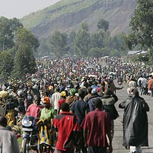 Some of the thousands of displaced people gather in the village of Kibati some 12 kilometers north of Goma in eastern Congo, Tuesday, Oct. 28, 2008. Thousands of refugees are fleeing fighting in eastern Congo while fighting continue between government forces and rebels of renegade Gen. Laurent Nkunda.(AP Photo/Karel Prinsloo) 