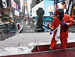 Francisco Mathurine, of the Times Square Alliance, clears snow from the steps in Father Duffy Square in New York, (Richard Drew/Associated Press) Francisco Mathurine, of the Times Square Alliance, clears snow from the steps in Father Duffy Square in New York, (Richard Drew/Associated Press)