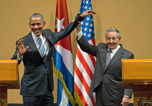 Cuban President Raul Castro, right, lifts up the arm of President Barack Obama at the conclusion of their joint news conference at the Palace of the Revolution, Monday, March 21, 2016, in Havana, Cuba. (AP Photo/Ramon Espinosa) ORG XMIT: XEM123