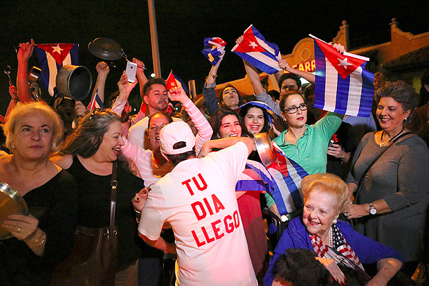 The Cuban community celebrates the announcement that Fidel Castro died as they gather in front La Carreta Restaurant early Saturday, Nov. 26, 2016, in Miami. Within half an hour of the Cuban government's official announcement that former President Fidel Castro had died, Friday, Nov. 25, 2016, at age 90, Miami's Little Havana teemed with life - and cheers. (David Santiago/El Nuevo Herald via AP) ORG XMIT: FLMEH107