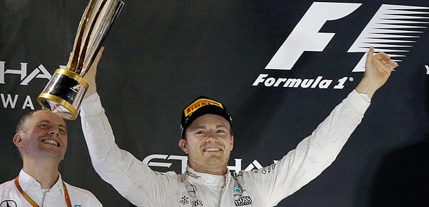 Mercedes driver Nico Rosberg of Germany celebrates on the podium after winning the 2016 world championship while teammate Mercedes driver Lewis Hamilton of Britain, right, applauds during the Emirates Formula One Grand Prix at the Yas Marina racetrack in Abu Dhabi, United Arab Emirates, Sunday, Nov. 27, 2016. Hamilton won the race but finished the championship in second place. (AP Photo/Luca Bruno) ORG XMIT: XAF149