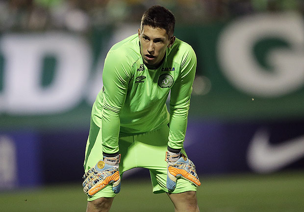 In this Nov. 23, 2016 photo, Brazil's Chapecoense goalkeeper Follmann, warms up prior to a Copa Sudamericana semifinal soccer match against Argentina's San Lorenzo in Chapeco, Brazil. Follmann is reported to be among those who survived when the charter plane he was on crashed into a Colombian hillside and broke into pieces, officials said Tuesday, Nov. 29. The aircraft was carrying the Brazilian soccer team and a group of sports journalists to a two-game Copa Sudamericana final. (AP Photo/Andre Penner) ORG XMIT: XAP119