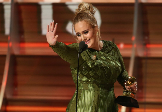 Adele waves to singer Beyonce who is in the audience as she and co-song writer Greg Kurstin (not pictured) accept the Grammy for Song of the Year for "Hello" at the 59th Annual Grammy Awards in Los Angeles, California, U.S., February 12, 2017. REUTERS/Lucy Nicholson TPX IMAGES OF THE DAY ORG XMIT: LOA818